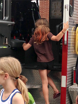 Little Girl Climbing into the Fire Truck
